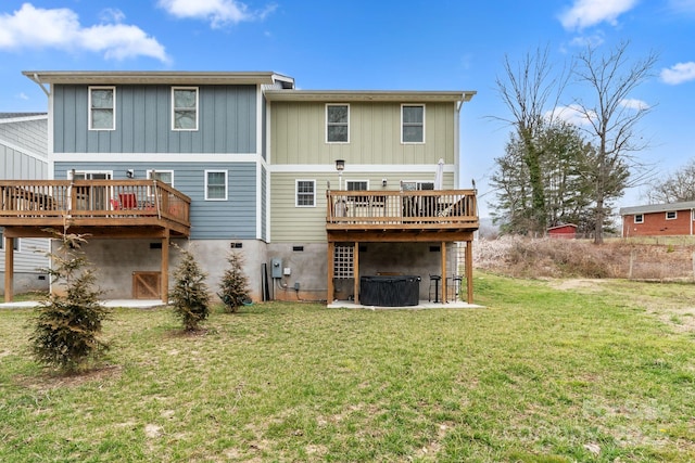 rear view of house with a deck and a yard