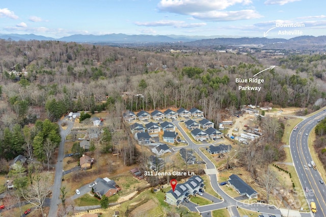 aerial view with a forest view, a residential view, and a mountain view