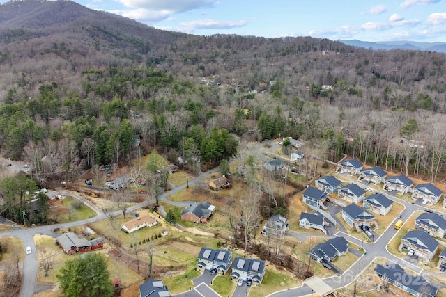 birds eye view of property with a residential view, a mountain view, and a forest view