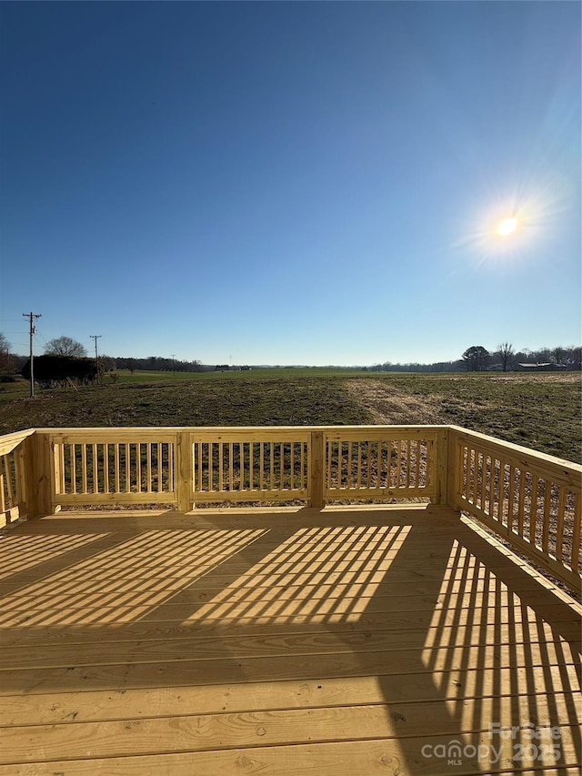 wooden deck featuring a rural view