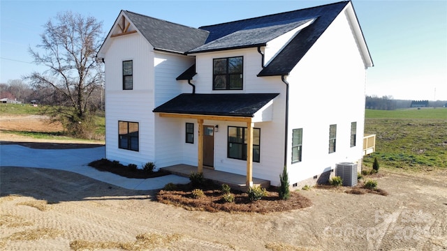 modern farmhouse with a porch, central AC, roof with shingles, concrete driveway, and crawl space