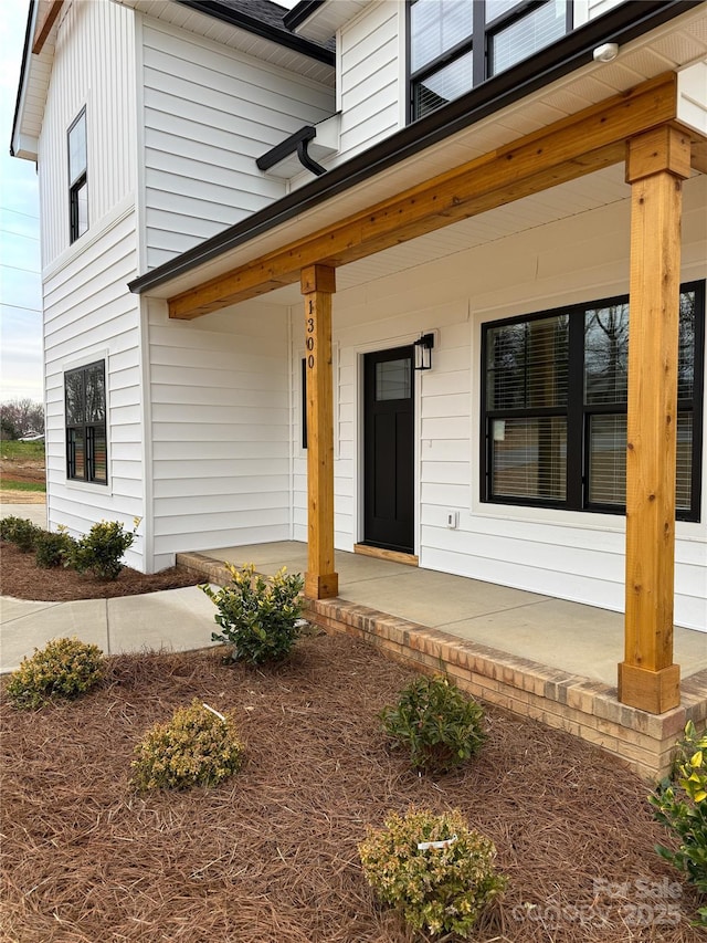 view of exterior entry with covered porch