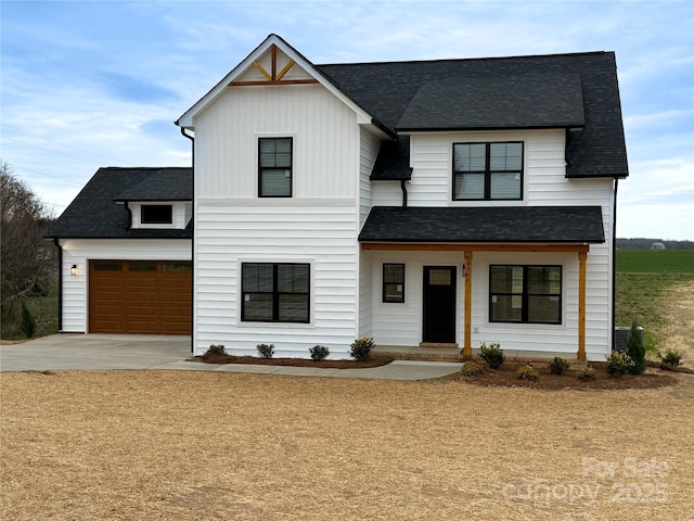 modern inspired farmhouse featuring covered porch, concrete driveway, an attached garage, and a shingled roof