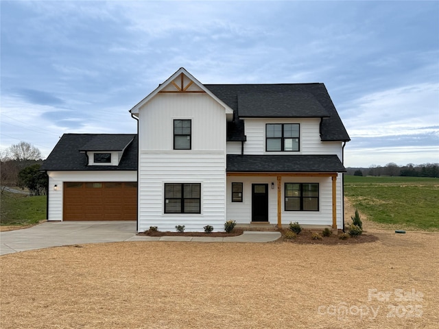 modern farmhouse with board and batten siding, a garage, driveway, and a shingled roof