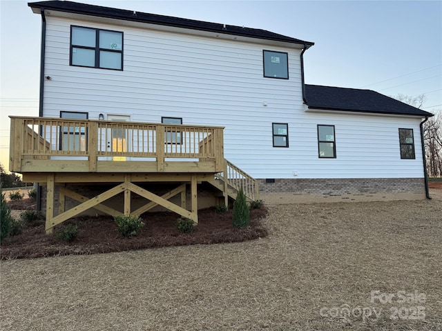 back of property featuring crawl space and a wooden deck