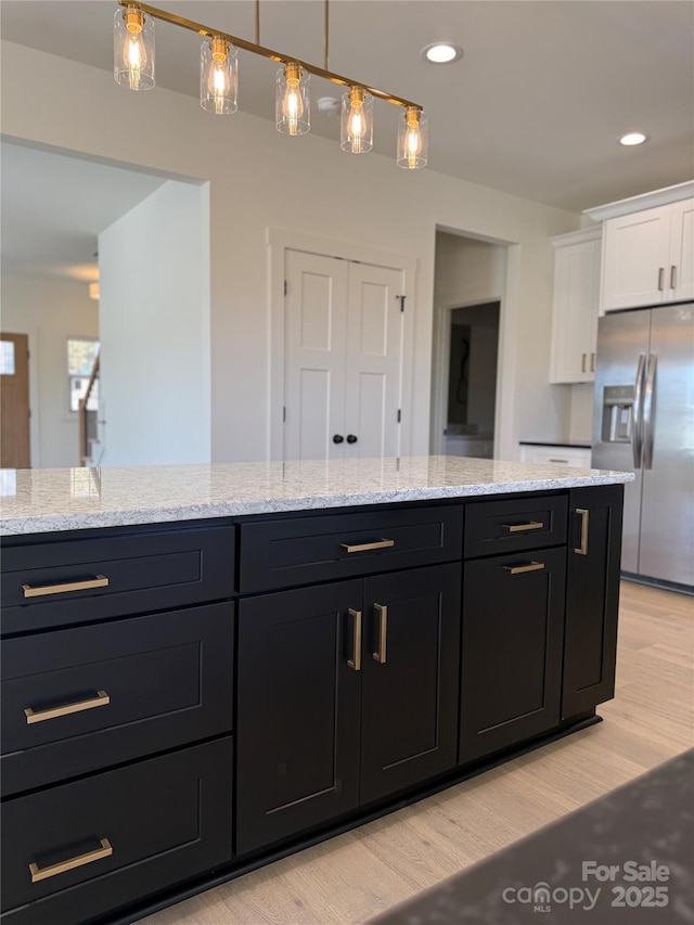 bathroom with recessed lighting, vanity, and wood finished floors