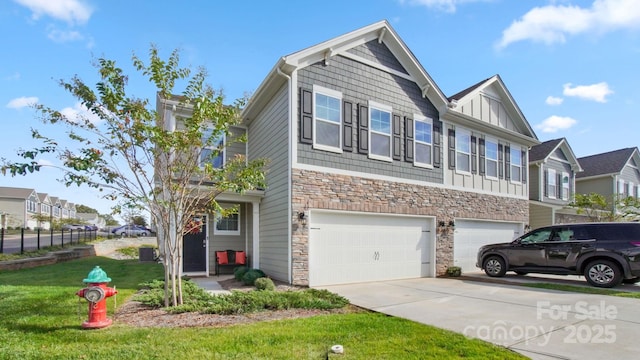 view of front of house featuring a front yard, a garage, a residential view, stone siding, and driveway