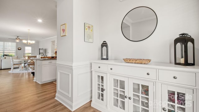 room details featuring recessed lighting, a chandelier, wood finished floors, and wainscoting