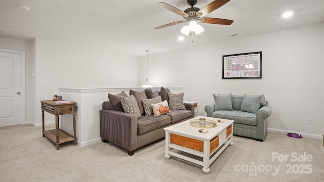 living area with light carpet, visible vents, and baseboards