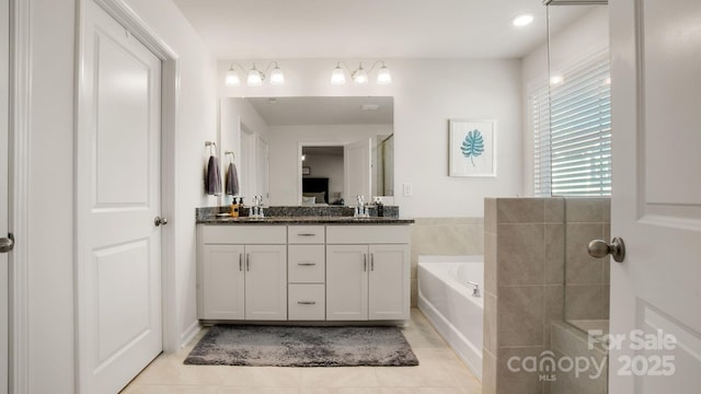 full bathroom featuring double vanity, tile patterned flooring, and a bath