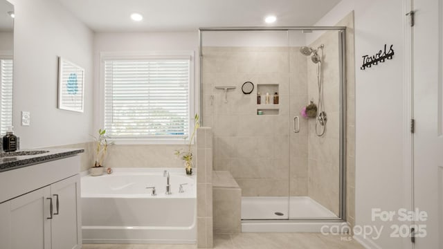 full bathroom with a stall shower, recessed lighting, a garden tub, and vanity