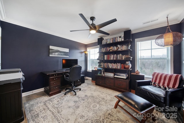 office space featuring visible vents, ornamental molding, a ceiling fan, wood finished floors, and baseboards