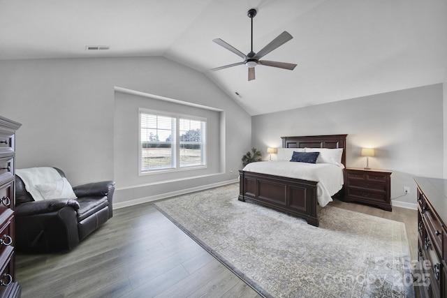 bedroom featuring lofted ceiling, wood finished floors, visible vents, and baseboards