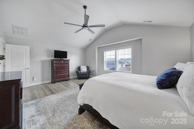 bedroom featuring a ceiling fan, lofted ceiling, visible vents, and light wood finished floors