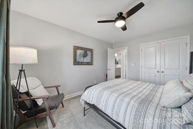 bedroom with a closet, ceiling fan, and baseboards