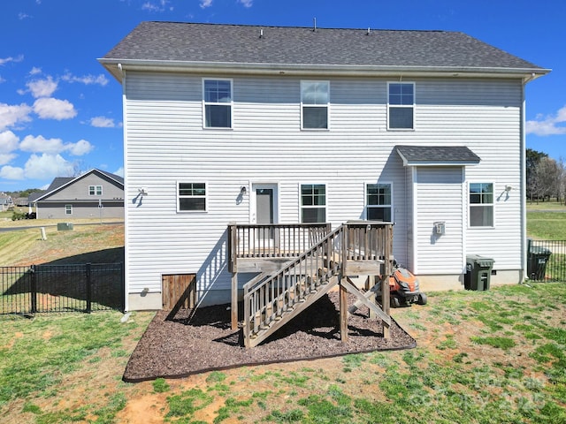 back of house with a deck, fence, stairway, and a lawn