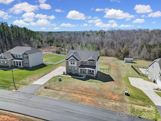 birds eye view of property featuring a view of trees