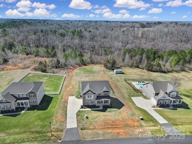 aerial view featuring a wooded view