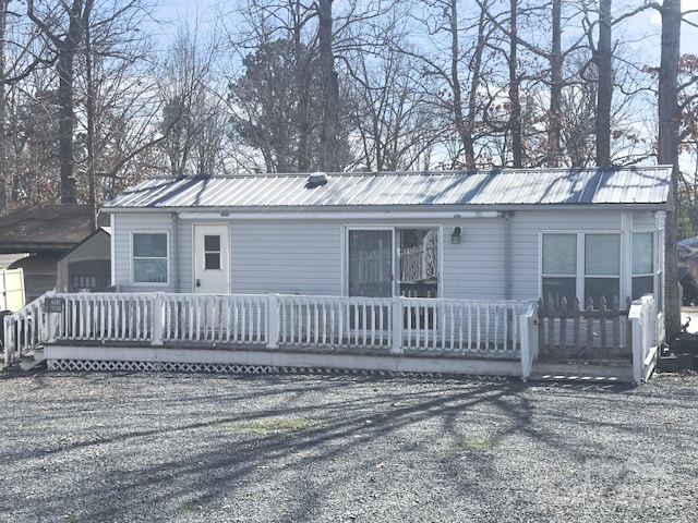 view of front of home featuring a deck and metal roof