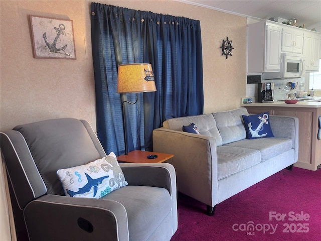 carpeted living room featuring a textured wall