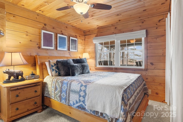 bedroom with ceiling fan, carpet floors, wooden walls, and wooden ceiling