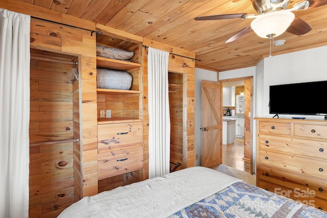 bedroom with light wood-style flooring and wooden ceiling