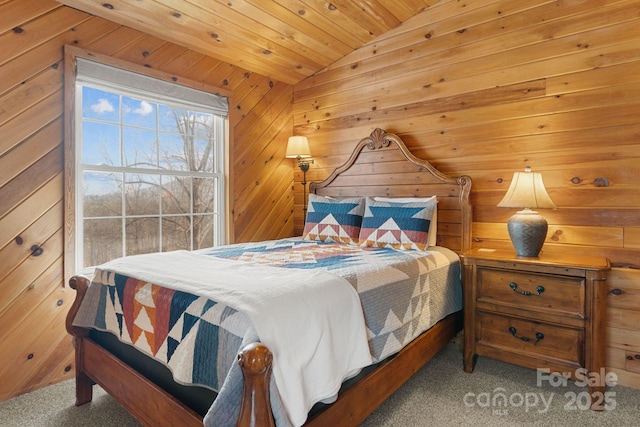 bedroom with wood ceiling, lofted ceiling, wooden walls, and carpet