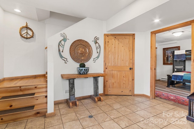 entrance foyer featuring light tile patterned flooring, recessed lighting, a baseboard heating unit, and baseboards