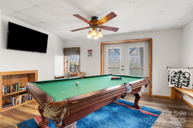 game room with billiards, a ceiling fan, wood finished floors, french doors, and a paneled ceiling