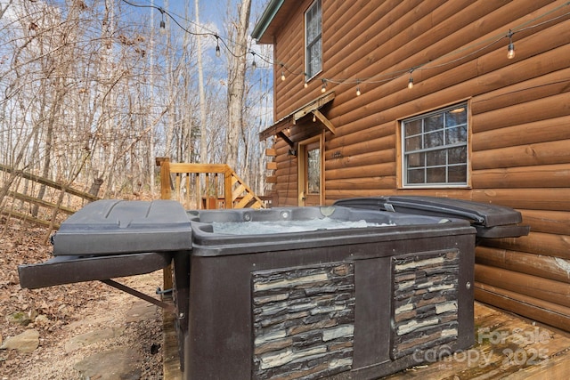 exterior details with log veneer siding and a jacuzzi