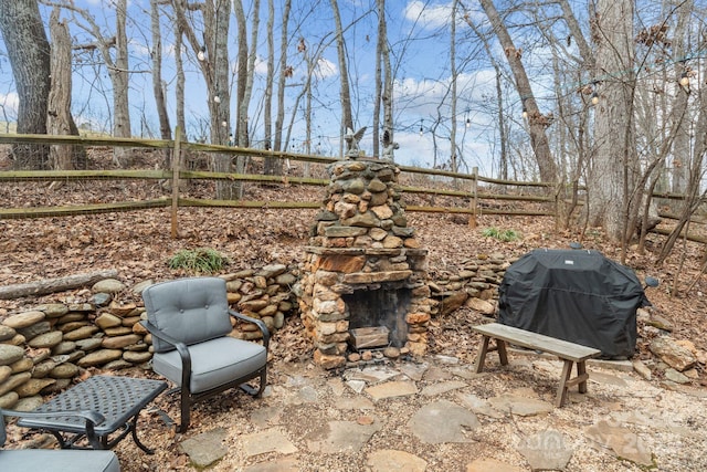 view of patio featuring area for grilling and fence