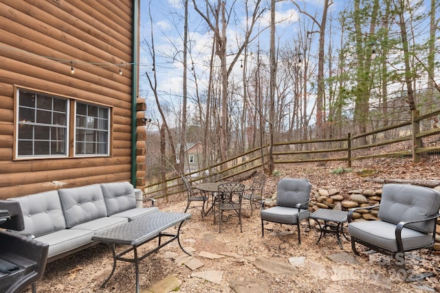 view of patio / terrace featuring an outdoor living space and fence