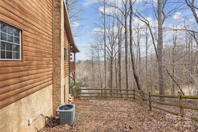 view of yard with cooling unit and fence