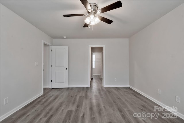 unfurnished bedroom featuring ceiling fan, baseboards, and wood finished floors