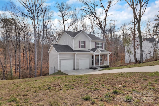 traditional-style home with a porch, a front yard, and driveway