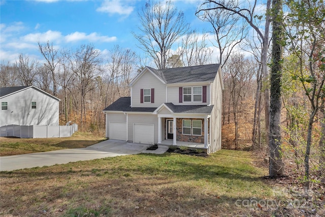 traditional home with concrete driveway, a porch, a front lawn, and stone siding