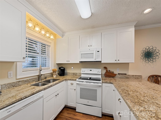 kitchen with white appliances, white cabinets, ornamental molding, dark wood-style flooring, and a sink