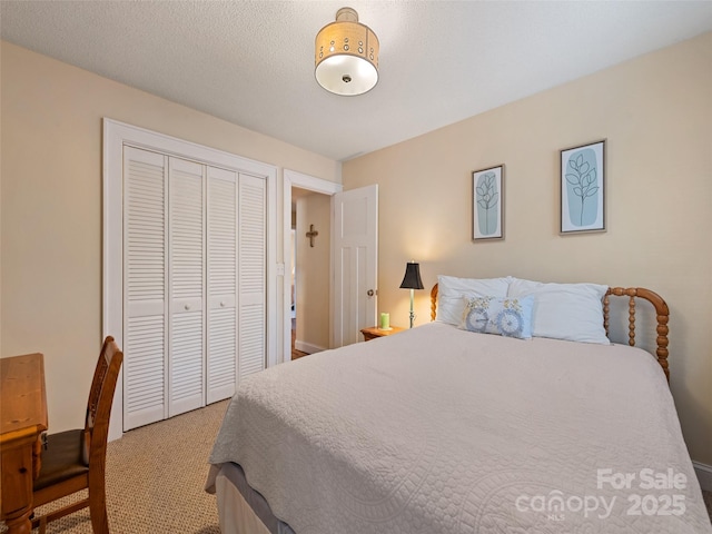 bedroom featuring a closet, light colored carpet, and a textured ceiling