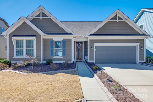 view of front of house featuring an attached garage, concrete driveway, and a front yard