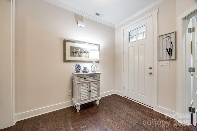 foyer entrance with ornamental molding, dark wood-type flooring, visible vents, and baseboards