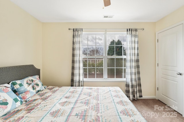 bedroom featuring carpet floors, visible vents, ceiling fan, and baseboards