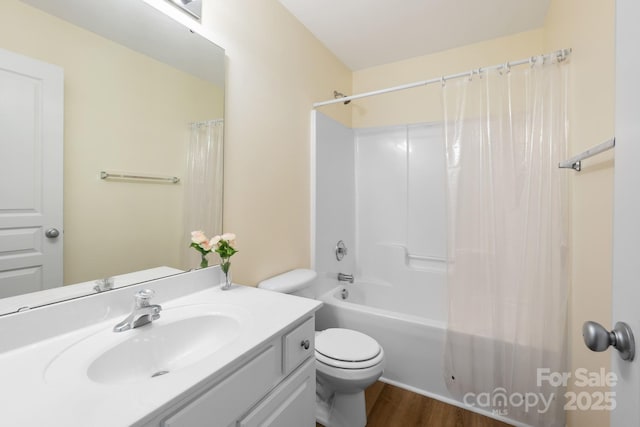 full bath featuring toilet, shower / bath combo, wood finished floors, and vanity