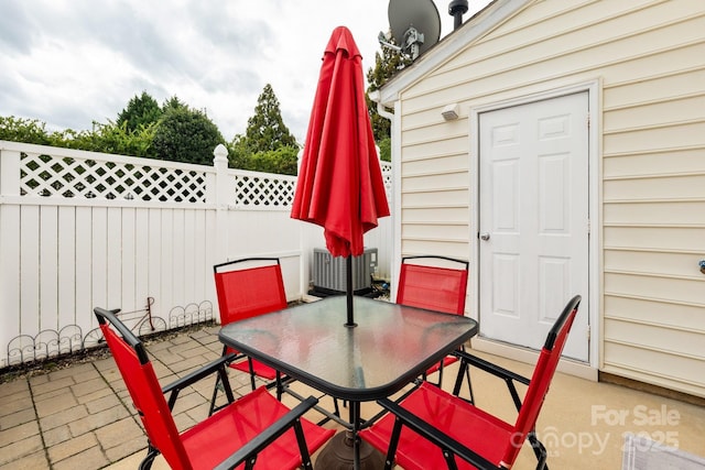 view of patio with fence and outdoor dining area