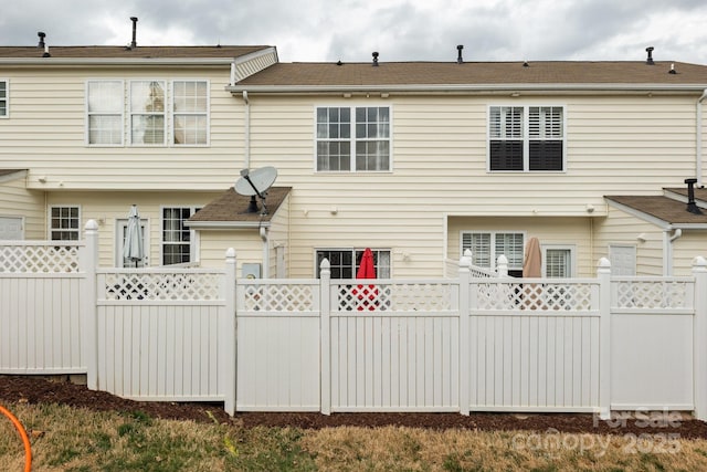 rear view of house with fence