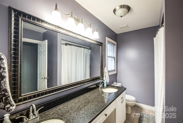 4825 1st Street Ct NW, Hickory, NC 28601 - full bath with double vanity, toilet, tile patterned floors, and baseboards