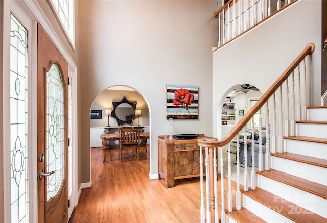 4825 1st Street Ct NW, Hickory, NC 28601 - foyer entrance with a towering ceiling, light wood-type flooring, stairs, baseboards, and arched walkways