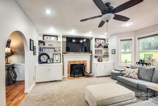 4825 1st Street Ct NW, Hickory, NC 28601 - living area with a textured ceiling, a fireplace, arched walkways, a ceiling fan, and recessed lighting