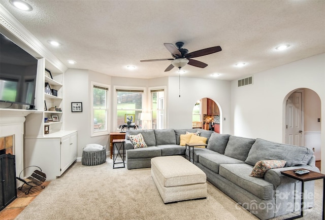 4825 1st Street Ct NW, Hickory, NC 28601 - living area featuring arched walkways, a fireplace, a ceiling fan, a textured ceiling, and recessed lighting