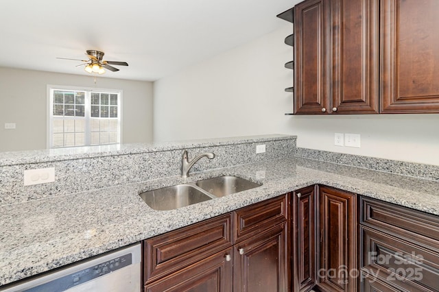 kitchen featuring light stone counters, a sink, a ceiling fan, dishwasher, and open shelves