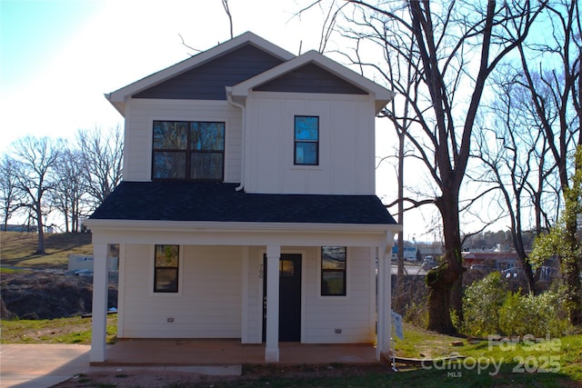 view of front of house featuring board and batten siding, covered porch, and a shingled roof